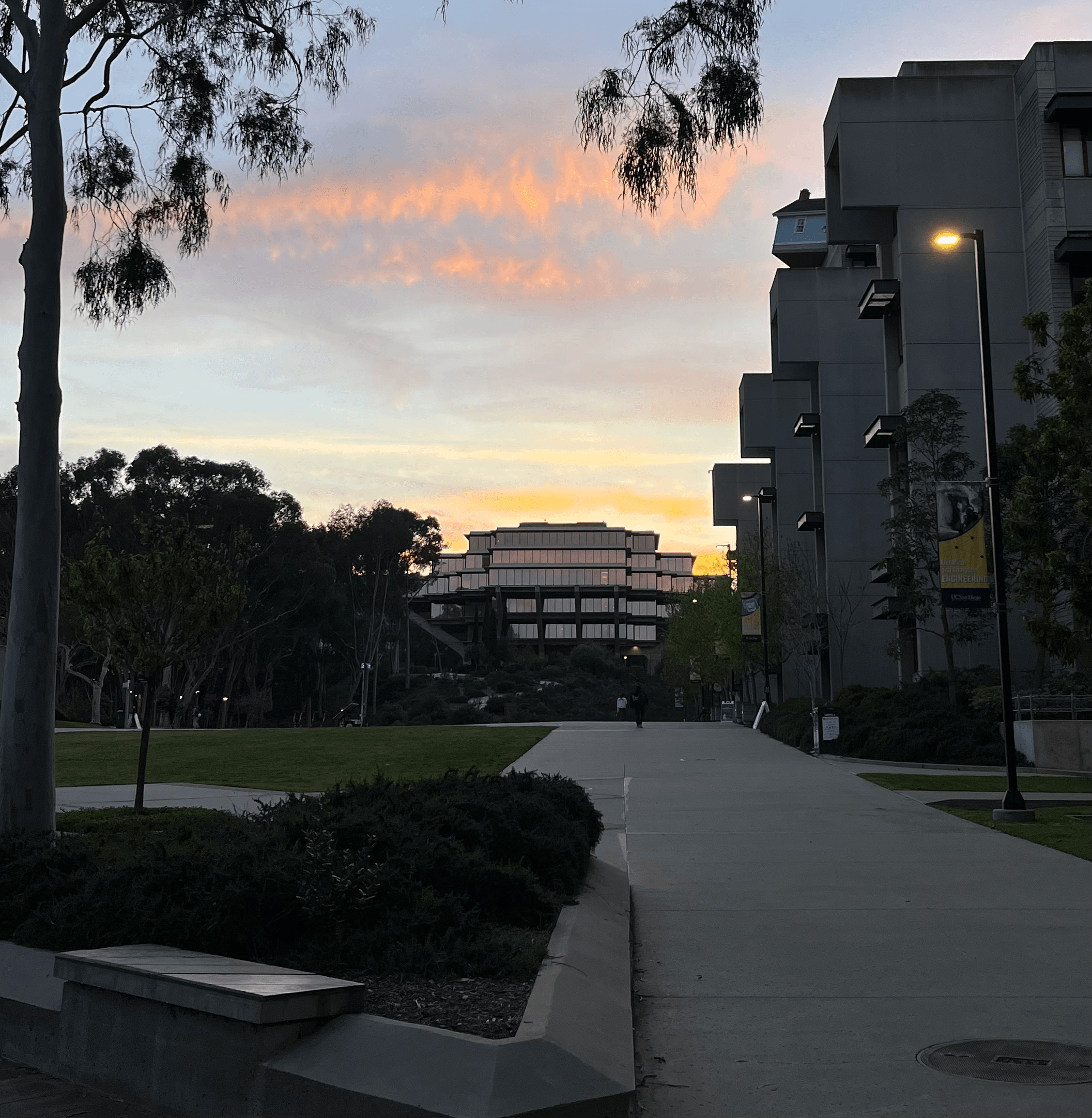 Students walking across a California university campus plaza.